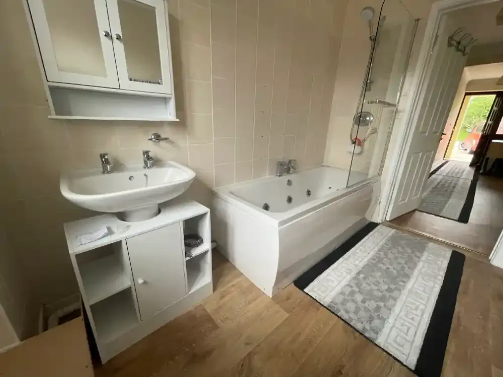 After: finished bathroom installation in Exeter - new basin, bath, tiling and flooring
