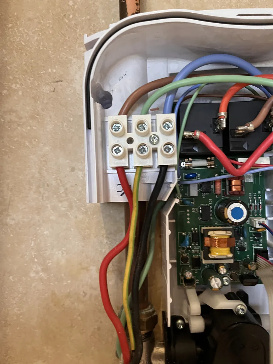 Inside an electric shower unit showing the wiring connections, Exeter