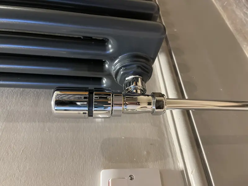 New thermostatic radiator valve fitted to a column radiator in Exeter