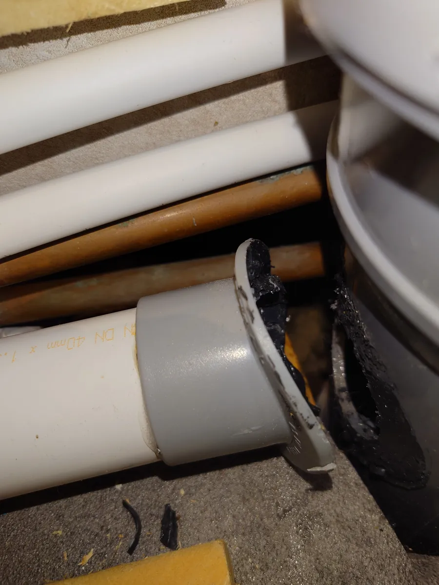 Leaking soil pipe joint bodged with sealant, Exeter