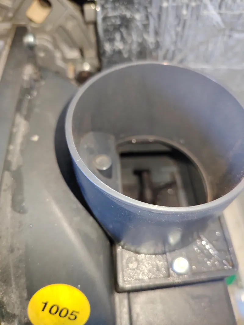 Burner air intake on a Riello RDB burner with the duct removed, looking into the fan housing