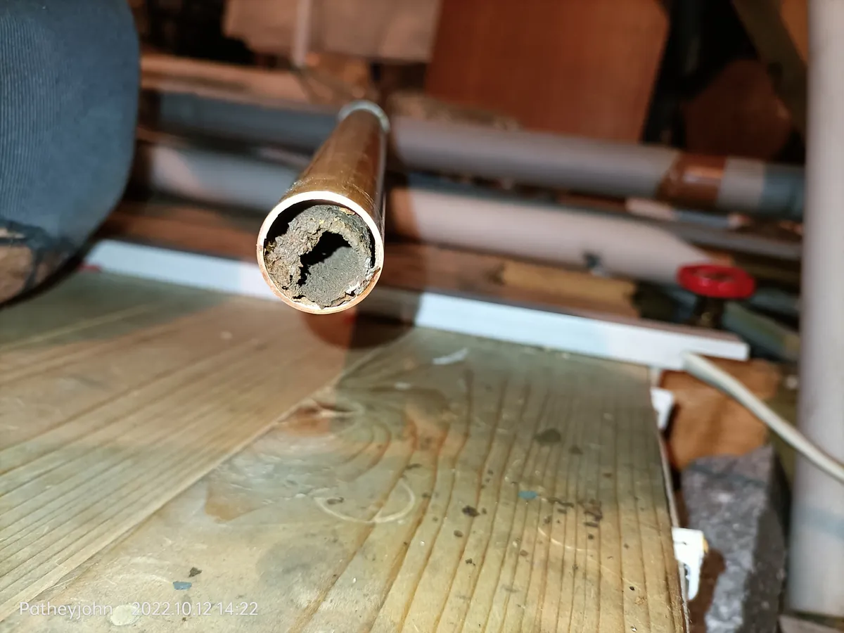 Blocked heating pipe end packed with sludge