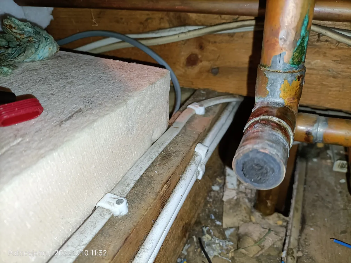 Heating pipe cut open showing sludge nearly blocking it