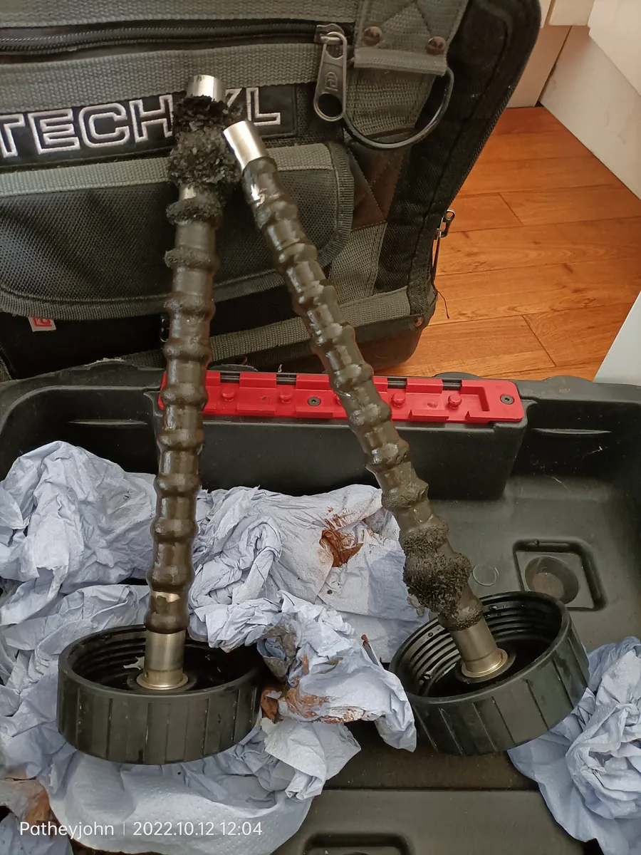 Magnetic filter from a central heating system in Exeter with its magnets caked in black sludge