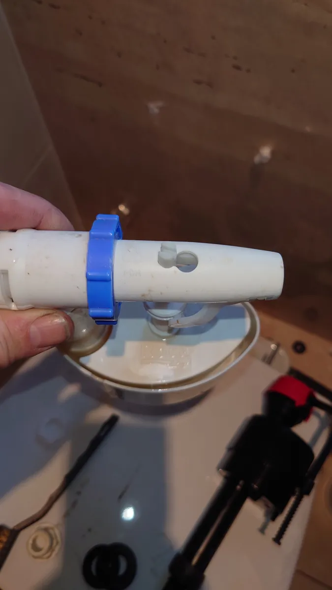 New toilet fill valve being fitted during a repair in Exeter