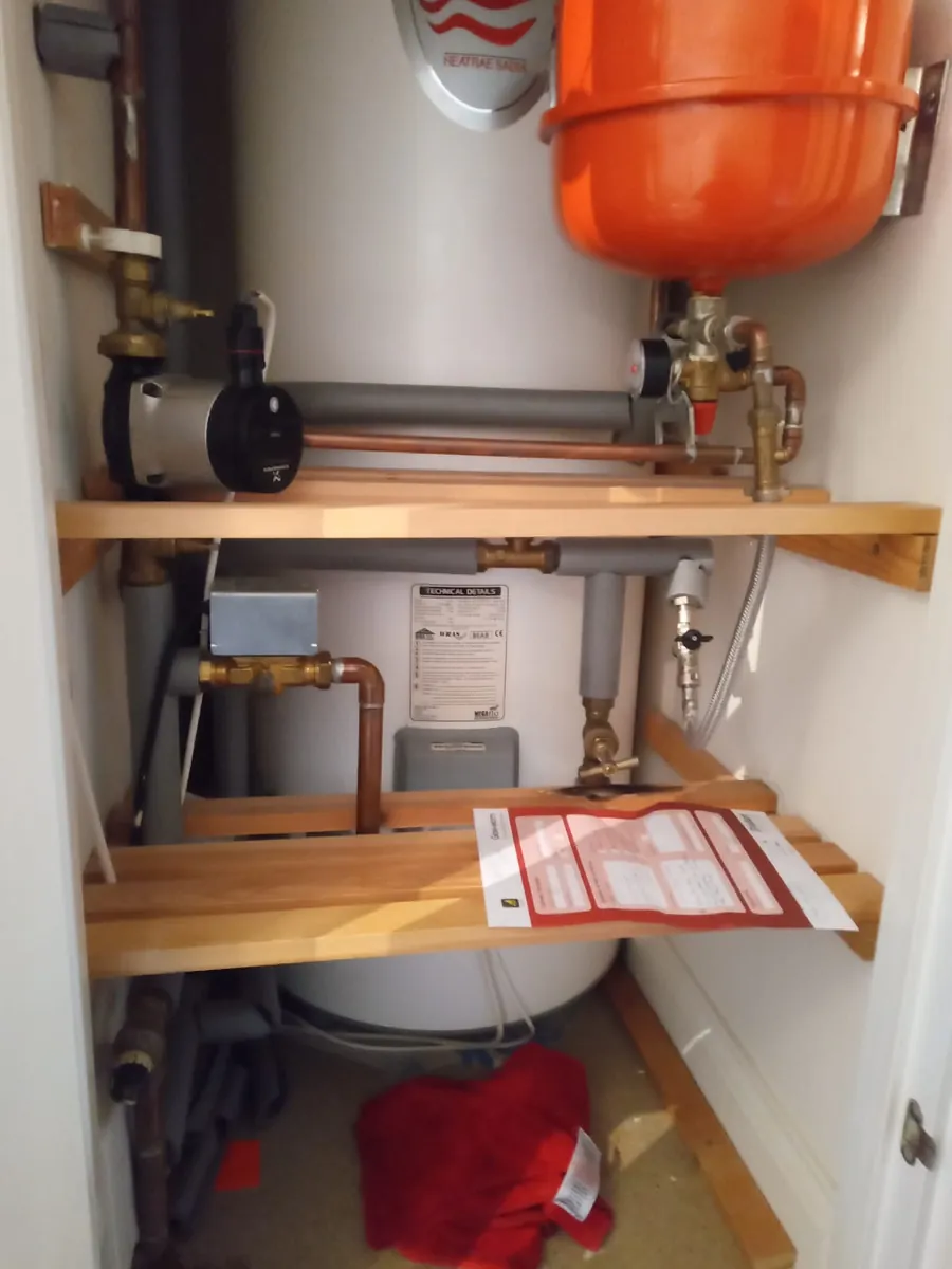 Unvented cylinder with pump and expansion vessel in an Exeter airing cupboard